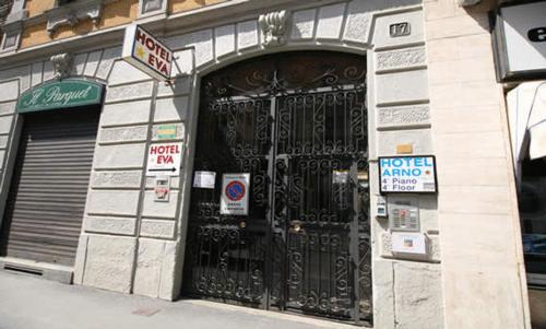 a store front with a black door with signs on it at Hotel Arno in Milan