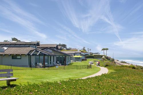 a house on a hill next to a sidewalk at WCH at Wave Crest Resort in Del Mar