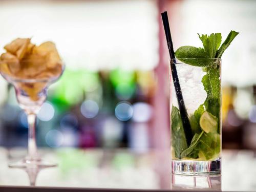 a glass with a drink and a martini glass with mint at Pullman London St Pancras in London