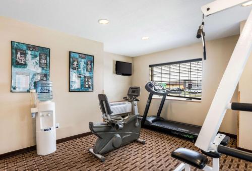 a gym with a treadmill and a chair in a room at MainStay Suites Cedar Rapids North - Marion in Cedar Rapids