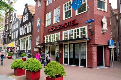 a building on a street with people walking in front of it at Avenue Hotel in Amsterdam