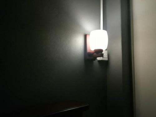 a light on a wall in a room at Cashew Nut Bungalow, Ko Mook in Koh Mook