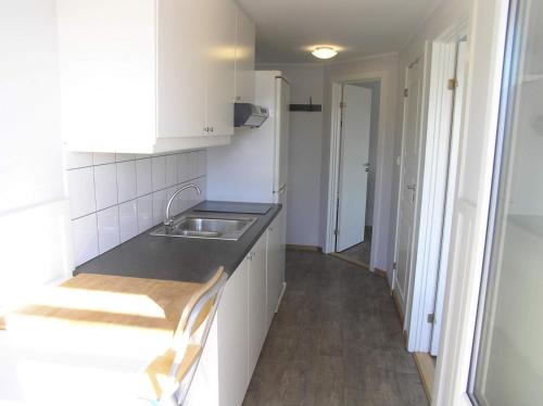a kitchen with a sink and a counter top at Bedder at Oslo Airport - serviced apartments in Jessheim
