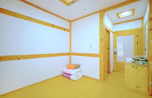 an empty room with a chair and a window at Leega Hanok in Jeonju