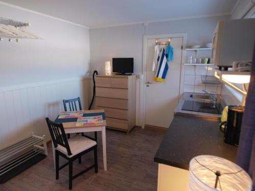 a small kitchen with a table and a chair in a room at Bedder at Oslo Airport - serviced apartments in Jessheim