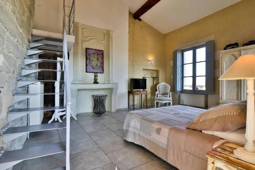 a bedroom with a bed and a staircase in a room at Le Posterlon in Caumont-sur-Durance