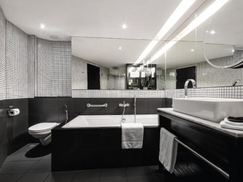 a bathroom with a sink, toilet and bathtub at Hard Rock Hotel Pattaya - SHA Extra Plus in Pattaya Central