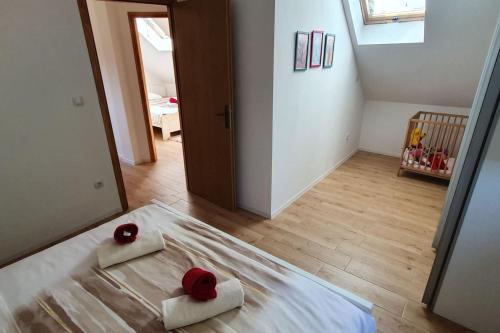 a bedroom with a bed with two roses on it at VILA LASOVIC + POOL + JACUZZI + SAUNA in Tuhelj