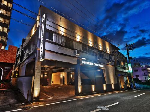 a building on a city street at night at Okinawa City Hotel in Okinawa City