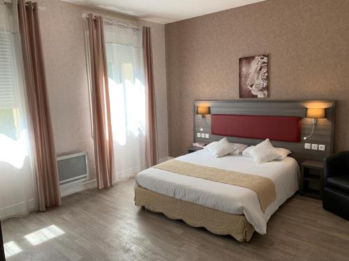 a bedroom with a large bed and a large window at Les Rives du Plantié in Le Temple-sur-Lot