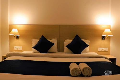 a bedroom with a large bed with black and white pillows at The Blue Jay Hostel - Dorms & Rooms in Rishīkesh