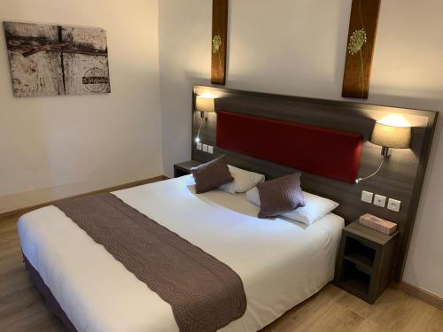 a bedroom with a large bed in a room at Les Rives du Plantié in Le Temple-sur-Lot