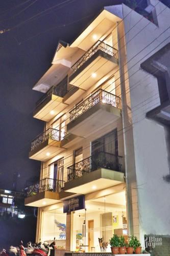 a tall building with balconies on the side of it at The Blue Jay Hostel - Dorms & Rooms in Rishīkesh