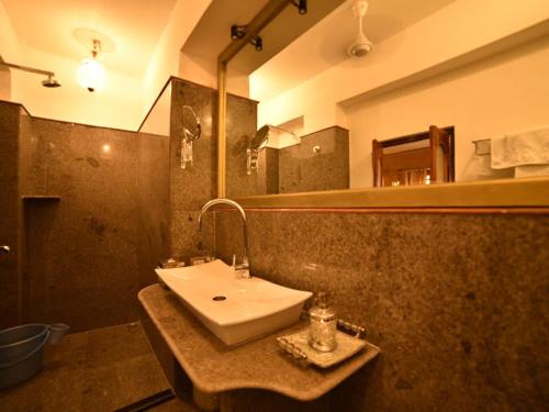 a bathroom with a sink and a mirror at Fort Villa in Jaisalmer
