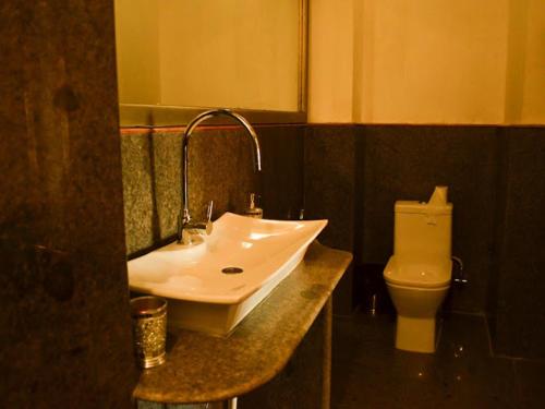 a bathroom with a sink and a toilet at Fort Villa in Jaisalmer