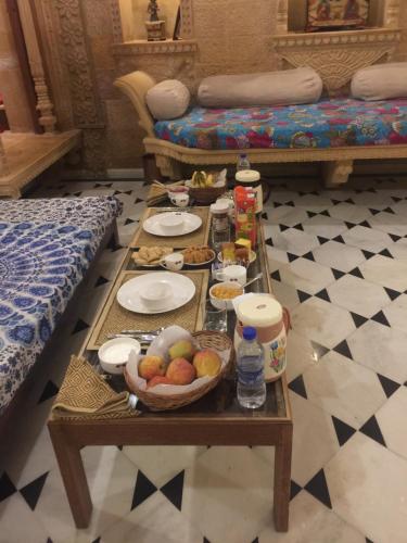 a table with food on it in a room at Fort Villa in Jaisalmer