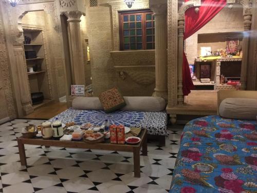 a room with a bed and a table with food on it at Fort Villa in Jaisalmer