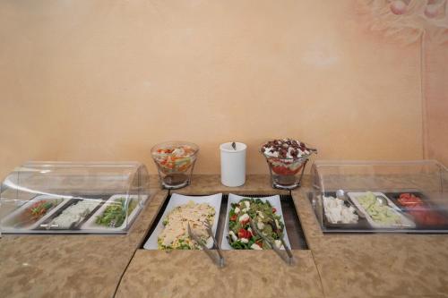 a table with three plates of food on it at Art Hotel Debono in Gouvia