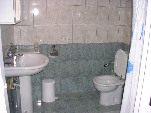 a bathroom with a sink and a toilet at Stefanos Apartments in Agia Fotia