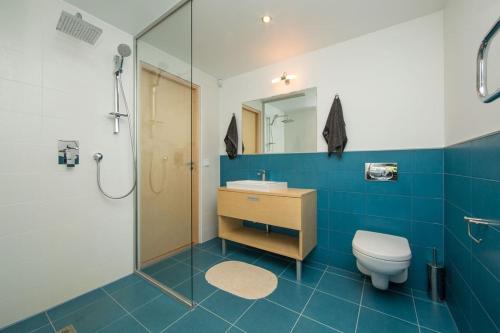 a bathroom with a toilet and a sink and a shower at Golf Villa near Tallinn in Manniva