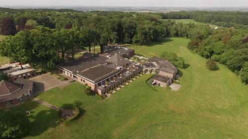 an aerial view of a large house on a green field at Fletcher Landgoed Hotel Holthurnsche Hof in Berg en Dal