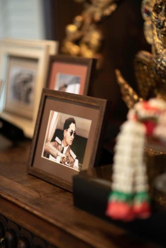a framed picture of a woman on a table at The Rose Residence, Bangkok in Bangkok