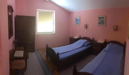 a bedroom with two beds and a window at Saraj Guest House in Kulen Vakuf