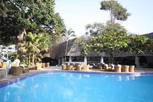 a swimming pool in front of a resort at Ocean Village Club (Adults Only) in Diani Beach