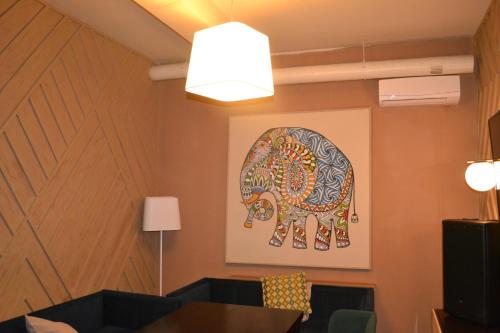 a room with a painting of a cow on the wall at Ayhan Hotel in Aktobe
