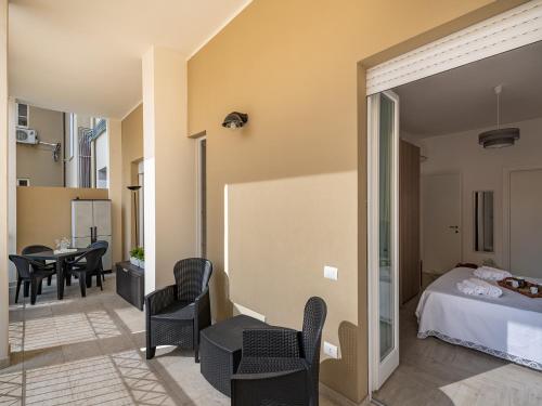 a bedroom with a bed and a table and chairs at Casa BEAR - City Centre in Cagliari