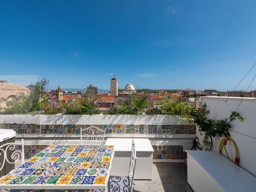 a balcony with a table and a view of the city at "Bea's Terrace" - Private Jacuzzi and panoramic rooftop in the City Centre in Cagliari