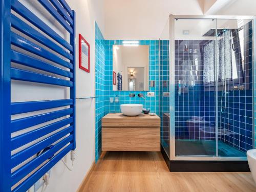 a bathroom with blue tiles and a glass shower at "Bea's Terrace" - Private Jacuzzi and panoramic rooftop in the City Centre in Cagliari