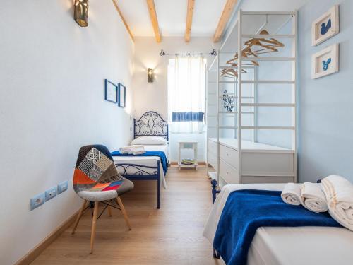 a bedroom with two beds and a desk and a chair at "Bea's Terrace" - Private Jacuzzi and panoramic rooftop in the City Centre in Cagliari