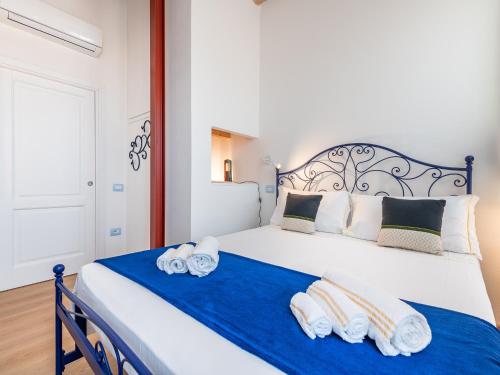 a bedroom with a large bed with towels on it at "Bea's Terrace" - Private Jacuzzi and panoramic rooftop in the City Centre in Cagliari