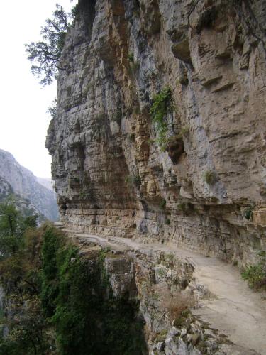 a rocky mountain with a dirt road on it at Hotel Spiridoula in Kleidonia