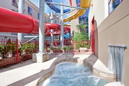 a water park in a building with a slide at Triple Play Resort Hotel & Suites in Hayden