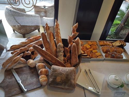 a table topped with a tray of bread and pastries at Thanakha Inle Hotel in Nyaungshwe Township