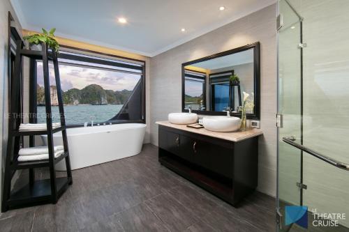 
a bathroom with a tub, sink, toilet and bathtub at Le Theatre Cruises - Wonder on Lan Ha Bay in Ha Long
