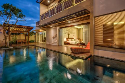 an indoor swimming pool in a house at The Miracle Villa Nusa Dua in Nusa Dua