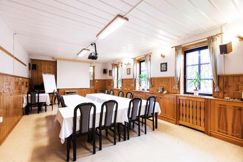 a large dining room with a table and chairs at Pension U Dvou čápů in Chocerady