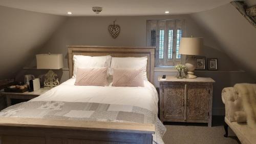 a bedroom with a large bed and a window at The Horse Inn Hurst in Hurstpierpoint