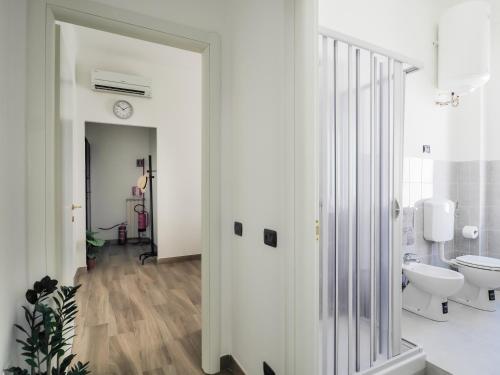 a white bathroom with a toilet and a sink at Brand New Cinque Terre Cozy Flat in La Spezia