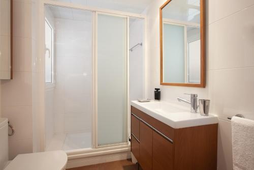 a bathroom with a shower and a sink and a mirror at Click&Flat Floridablanca in Barcelona