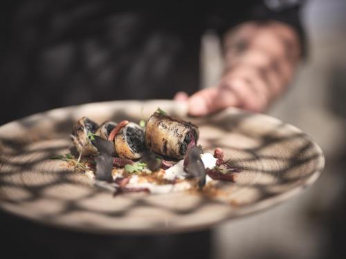a person holding a plate with food on it at Zante Maris Suites - Adults Only in Tsilivi