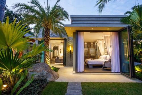 a bedroom in a villa with a bed at Villa on The Rocks, 4 bedrooms, Phuket in Surin Beach