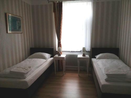 two beds in a room with a window at Liahof in Ullared