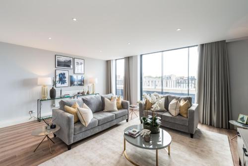 a living room with a couch and a table at The Carlyle by Nestor in London