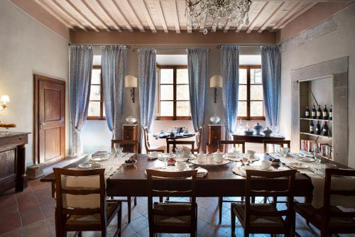 a dining room with a large wooden table and chairs at Palazzo Malaspina B&B in Tavarnelle in Val di Pesa