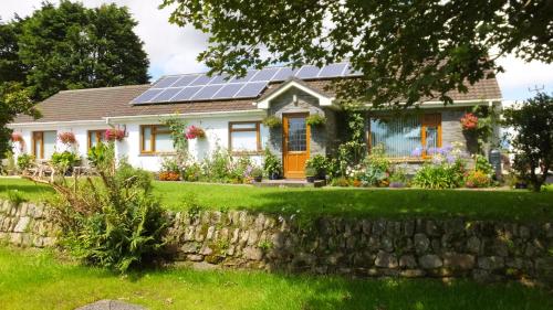 a house with solar panels on the roof at Rose Vean Bed & Breakfast in Helston
