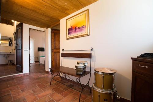 a living room with a table and a drum at Casali Marchigiani - Ville vacanza private con piscina in Ostra
